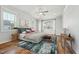 Bright main bedroom with hardwood floors, windows, and stylish furnishings at 654 Christian Light Rd, Fuquay Varina, NC 27526