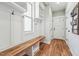 Bright mudroom features coat hooks, bench with storage, and hardwood floors at 654 Christian Light Rd, Fuquay Varina, NC 27526