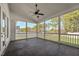 This screened-in patio features a ceiling fan and an open design to capture the beauty of nature at 654 Christian Light Rd, Fuquay Varina, NC 27526