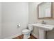 Charming powder room with a pedestal sink and decorative mirror at 654 Christian Light Rd, Fuquay Varina, NC 27526
