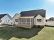 Beautifully landscaped backyard with a white vinyl fence, a patio and a screened porch at 654 Christian Light Rd, Fuquay Varina, NC 27526