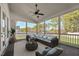 A cozy screened porch featuring comfortable seating, area rug, and a ceiling fan at 654 Christian Light Rd, Fuquay Varina, NC 27526