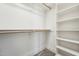 A walk-in closet with shelving and hanging rods provides ample storage space in a carpeted room at 654 Christian Light Rd, Fuquay Varina, NC 27526
