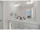 Bathroom vanity with double sinks, white cabinets, and a large mirror at 781 Fireball Ct, Knightdale, NC 27545