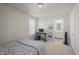 Bedroom featuring a desk area, computer, and a bed with patterned comforter at 781 Fireball Ct, Knightdale, NC 27545