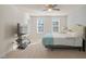 Bright bedroom with a large bed, carpeting, and natural light from two windows at 781 Fireball Ct, Knightdale, NC 27545