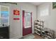 Functional entryway with shoe racks and a red door at 781 Fireball Ct, Knightdale, NC 27545