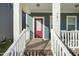 Front porch of the house with a red door and white columns at 781 Fireball Ct, Knightdale, NC 27545