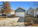 Detached garage with a driveway and white door providing secure parking at 781 Fireball Ct, Knightdale, NC 27545