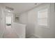Upstairs hallway with white trim, natural light, and neutral carpeting at 781 Fireball Ct, Knightdale, NC 27545