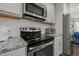 Modern kitchen featuring stainless steel appliances and granite countertops at 781 Fireball Ct, Knightdale, NC 27545