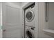 A compact laundry area featuring a stacked washer and dryer in a closet at 781 Fireball Ct, Knightdale, NC 27545