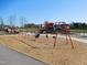 Community playground with swings, play structure, and ample wood mulch for safe play at 781 Fireball Ct, Knightdale, NC 27545