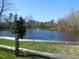 Picturesque community pond featuring a fountain, surrounded by greenery and a wooden fence at 781 Fireball Ct, Knightdale, NC 27545