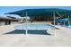 Community pool with clear blue water, shade structures, and comfortable lounging areas at 781 Fireball Ct, Knightdale, NC 27545