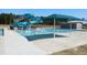 Inviting community pool featuring a water slide, lap lanes, shade canopy, and modern design at 781 Fireball Ct, Knightdale, NC 27545