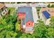 Charming red home with decks and grey roof, surrounded by lush green trees at 807 Vickers Ave, Durham, NC 27701