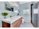 Bathroom features double vanity, mosaic tile floor, and shower with glass door at 807 Vickers Ave, Durham, NC 27701