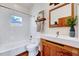Bright bathroom features white subway tile, a rustic wood vanity and accent mirror at 807 Vickers Ave, Durham, NC 27701