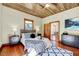 Well-lit bedroom showcasing hardwood floors, two black nightstands, and a comfortable queen bed at 807 Vickers Ave, Durham, NC 27701