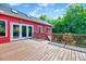 Large wooden deck with railing offers a view of a lush backyard and blue skies at 807 Vickers Ave, Durham, NC 27701