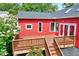 Red home with a wooden deck and a view of trees and landscaping in the background at 807 Vickers Ave, Durham, NC 27701