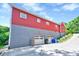 Exterior view of a red home with a gray foundation and a two-car garage at 807 Vickers Ave, Durham, NC 27701