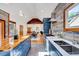 Modern kitchen with custom cabinetry, stainless steel appliances, and a breakfast bar that is open to dining area at 807 Vickers Ave, Durham, NC 27701