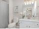Well-lit bathroom featuring modern fixtures, a shower-tub combo, and elegant decor at 904 Amersham Ln, Wake Forest, NC 27587