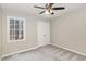 Charming bedroom with a ceiling fan, neutral walls, plush carpeting, and a double door closet at 904 Amersham Ln, Wake Forest, NC 27587