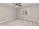 Cozy bedroom with plush carpet, ceiling fan, and a window overlooking a serene outdoor view at 904 Amersham Ln, Wake Forest, NC 27587