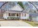 Charming home with a well-maintained lawn, inviting front porch, and a driveway at 904 Amersham Ln, Wake Forest, NC 27587
