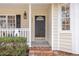 Close up of the front door with a decorative light fixture and nicely landscaped yard at 904 Amersham Ln, Wake Forest, NC 27587