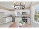 Well-lit kitchen featuring stainless steel appliances and bright white cabinetry at 904 Amersham Ln, Wake Forest, NC 27587