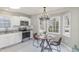 Eat-in kitchen area featuring stainless steel appliances and a stylish chandelier at 904 Amersham Ln, Wake Forest, NC 27587