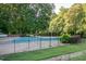 A community pool surrounded by grass and trees at 904 Saint Catherines Dr, Wake Forest, NC 27587