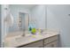 Bright bathroom with dual sink vanity, modern fixtures, and a large mirror reflecting the blue walls at 93 Fair Child Rd, Spring Lake, NC 28390