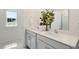 Bathroom featuring double sinks, modern fixtures, and a window offering natural light at 93 Fair Child Rd, Spring Lake, NC 28390