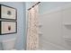Bathroom featuring a white shower tub with a colorful polka-dotted curtain and light blue walls at 93 Fair Child Rd, Spring Lake, NC 28390