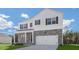 Two-story home featuring stone accents, white siding, black shutters and a well-manicured front lawn at 93 Fair Child Rd, Spring Lake, NC 28390
