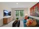 Relaxing living room with stylish decor, large window, plush sofa, and a mounted television at 93 Fair Child Rd, Spring Lake, NC 28390