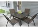 Relaxing patio with a glass-top table, four chairs, and refreshing lemonade, perfect for outdoor enjoyment at 97 Buckstone Pl, Willow Springs, NC 27592