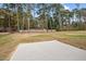 Large grassy backyard with mature trees and a concrete patio area at O Shortline Rd, Roxboro, NC 27574