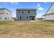 Two-story home exterior with green lawn and a small back patio at O Shortline Rd, Roxboro, NC 27574