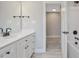 Well-lit bathroom with a white vanity, matte black fixtures, and access to the shower and hallway at O Shortline Rd, Roxboro, NC 27574