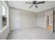 This cozy bedroom features plush carpeting, a ceiling fan, and ample natural light at O Shortline Rd, Roxboro, NC 27574