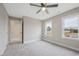 Spacious bedroom with neutral carpet, ceiling fan, and two large windows providing lots of natural light at O Shortline Rd, Roxboro, NC 27574