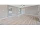 Spacious bedroom featuring wood-look flooring, neutral walls, a ceiling fan, and natural light from two windows at O Shortline Rd, Roxboro, NC 27574