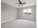 Comfortable bedroom with neutral carpet, ceiling fan, and a large window overlooking the neighborhood park at O Shortline Rd, Roxboro, NC 27574