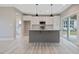 Modern kitchen with white cabinets, granite countertops, a gray island and stainless steel appliances at O Shortline Rd, Roxboro, NC 27574
